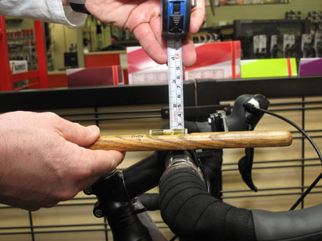 ERIK'S Trufit Bike Fit Specialist measuring length of handlebars on bike